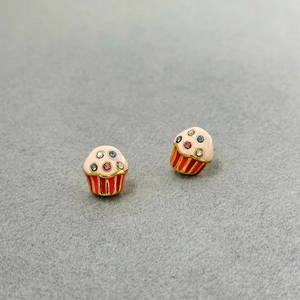 Pink cupcake stud earrings with colorful zircon stones on grey felt background