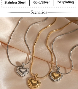 Detailed view of gold and silver heart necklaces on silk with PVD plating text