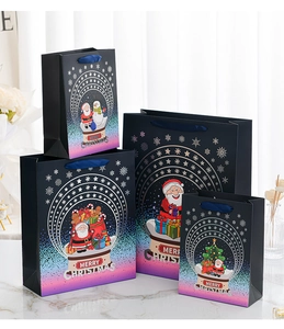 Detailed view of four assorted Christmas gift bags with gold foil and silk handles