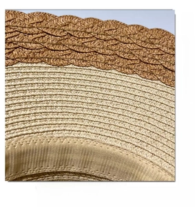 Detailed close-up of woven paper straw texture with brown wave edge on summer sun hat