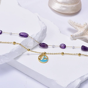 Ocean-themed gold layered anklet with purple natural stone and whale tail pendant