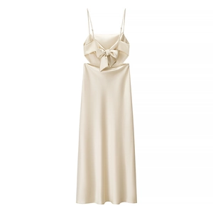 Elegant champagne satin maxi dress with spaghetti straps and bow back detail on white background