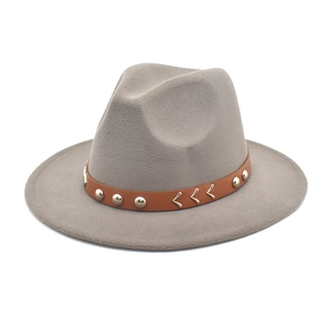 Detail of grey wool felt fedora featuring brown leather band with metal rivets
