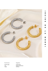Detail of twisted rope texture on 18K gold and silver C-shaped stainless steel earrings