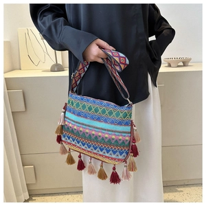 Detail of bohemian crossbody bag with colorful diamond weave pattern and fringe tassels