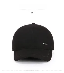 Detail of a dark black wool winter baseball cap showing the side metallic Sport tag