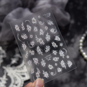 Vue détaillée d'autocollants 5D pour ongles à fleurs blanches et accents de lignes argentées