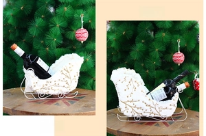 White plush Christmas sleigh wine holder with gold floral embroidery in two sizes