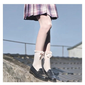 White cotton crew socks with pink bows paired with black loafers for school style