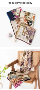 Detailed close-up of retro floral pattern and hemmed edges on a vintage square silk scarf