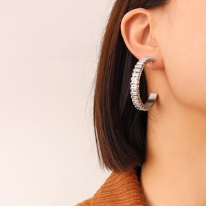 Chic silver C-shaped earrings with rectangular zircon inlay shown on a model