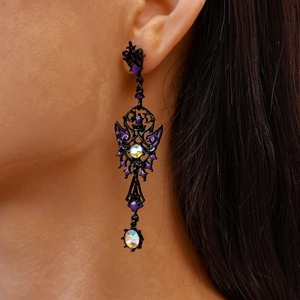 Detail of gothic dark butterfly drop earring with purple enamel and iridescent crystals