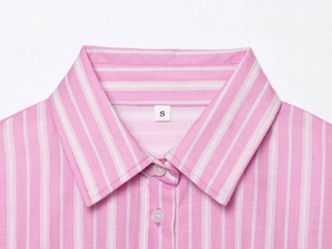 Close-up detail of pink striped shirt collar with neat stitching and small size S label