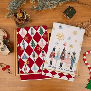 Close-up of Christmas kitchen towels featuring Nutcracker and ballerina prints on wood