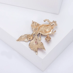 Detailed back view showing the gold-plated goldfish brooch pin and textured metal finish