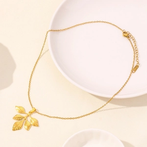 Detail of 18K gold-plated ginkgo leaf pendants on a thin stainless steel chain