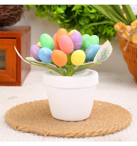 Detail of colorful speckled Easter egg plant in white pot for festive garden decoration