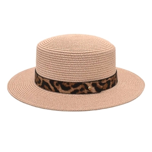 Dettaglio cappello di paglia a corona piatta con fascia leopardata e borchia dorata