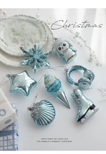 Flat lay of ice blue Christmas ornaments set featuring glittery snowflake and owl charms