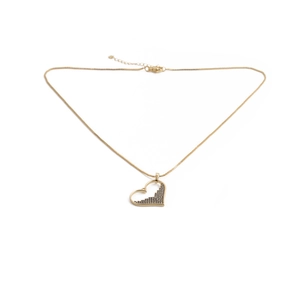 Close-up of golden hollow heart necklace featuring black zircon devil eye detail