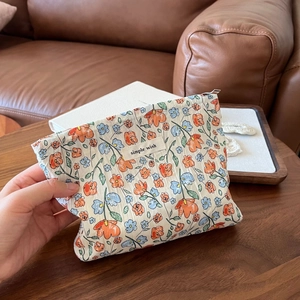 Detailed macro of floral crinkle fabric texture and Simple Wish label on cosmetic bag