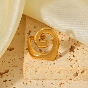 Minimalist 18K gold plated spiral stainless steel open ring on a travertine stone