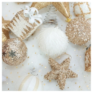 Flat lay of champagne gold star and plush ball ornaments with glitter details