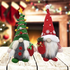 Detail of Christmas gnome plush toys with 3D hats and festive striped arms on wood