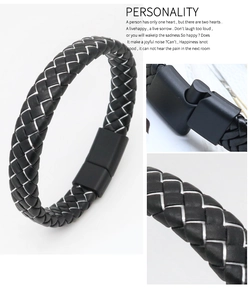 Detail view of woven black leather bracelet featuring white stitching and magnetic buckle