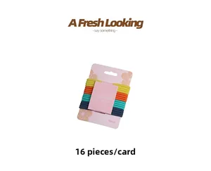 Detailed view of 16 multicolor elastic hair ties with ribbed texture on pink card display