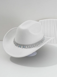 Detailed view of white felt cowboy hat with silver rhinestone band and metal studs