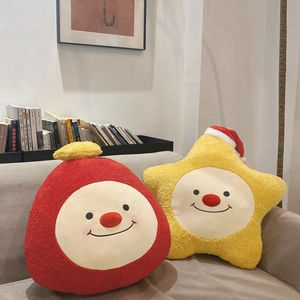 Plüschige Stern- und Mondkissen mit lächelnden Gesichtern auf einem Sofa im Wohnzimmer