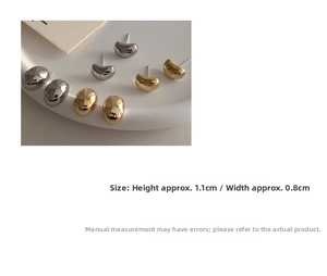 Close-up of small oval metal bean studs in gold and silver, size 1.1cm by 0.8cm