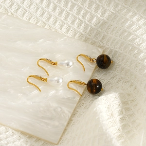 Elegant gold drop earrings featuring white pearls and tiger eye stones with zircon inlay