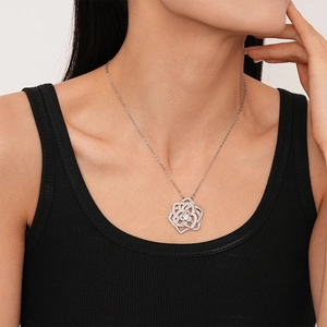 Elegant silver-toned rose pendant necklace with shimmering zircon stones on a model