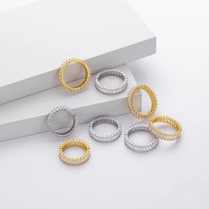Eternity rings with rectangular cubic zirconia in gold and silver finish on white background