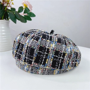 Detail of tweed checkered beret with colorful fibers and thick woven texture
