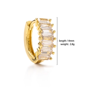 Detail view of 14mm gold huggie hoop earrings with baguette-cut zircon inlay