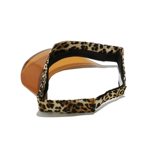 Detail of leopard print head band and translucent orange sun visor on an open-top hat