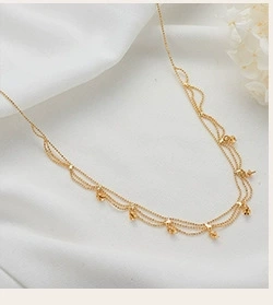 Close-up of 14K gold plated cubic zirconia link on elegant white silk fabric