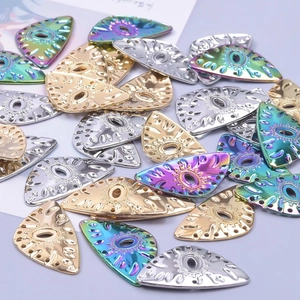 Polished stainless steel eye-shaped jewelry charms in gold, silver, and rainbow colors