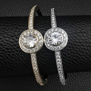 Detailed macro view of gold and silver irregular bracelets with halo zircon settings