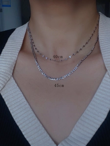 Model wearing 40cm and 45cm silver steel chains in minimalist and Figaro styles