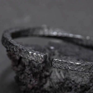 Men's vintage black Mobius cuff bracelet with a unique rugged rock texture finish