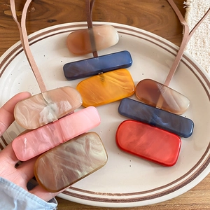 Detailed macro of acrylic rectangle pendants with marble patterns in morandi colors