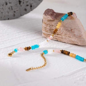 Detail of multi-colored natural stone beaded bracelet with 18k gold-plated lobster clasp