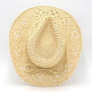 Detailed weave pattern of the hollow-out straw hat featuring a decorative bow knot