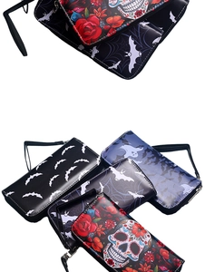 Detailed pile of long zip wallets with gothic skull, bat, and rose embossed patterns