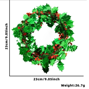 Christmas wreath with green tinsel, red berries, and 23cm diameter measurements