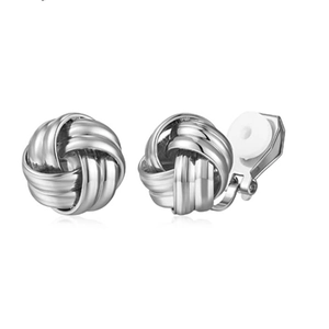 Detailed macro view of silver geometric knot ear clips with white comfort pads